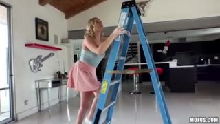 Blonde chick trying to change a lightbulb