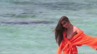 Beautiful teen Indiana Belle enjoys walk on beach