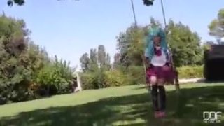 Blue haired teen masturbates in a swing