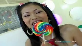 Asian Nina sucks on a lollipop and a cock